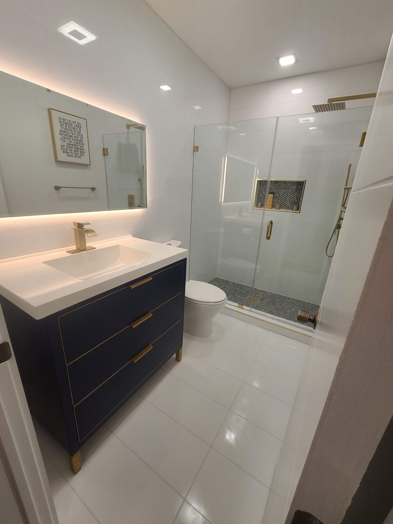 Bathroom remodeling with navy vanity and glass shower